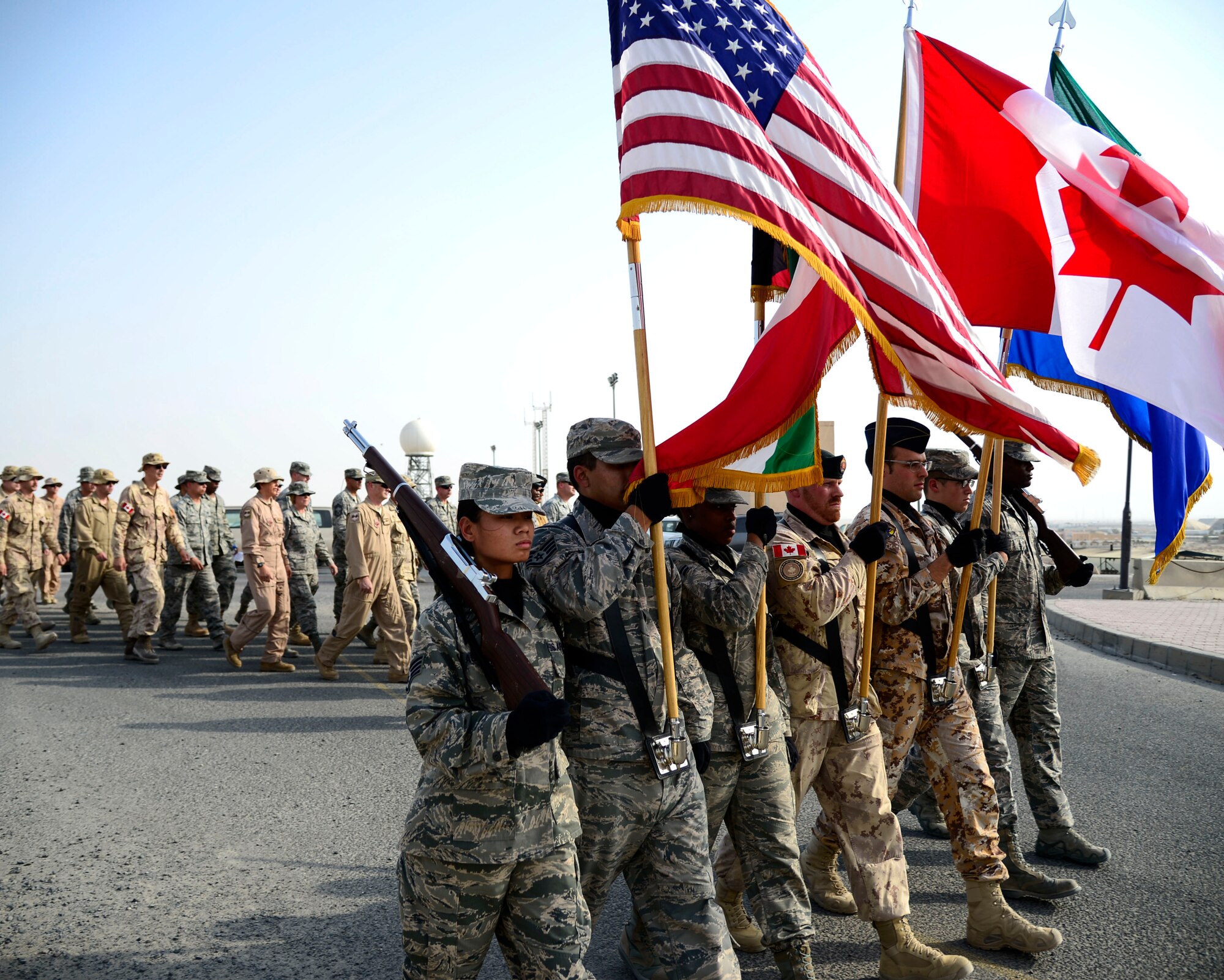 A coalition honor guard marches to a 9/11 memorial during a tribute ceremony at an undisclosed location in Southwest Asia, Sept. 11, 2015. Fourteen years after 9/11, America and its allies are still in the fight against acts of terrorism with Operation Inherent Resolve, the intervention against the Islamic State of Iraq and the Levant (ISIL). (U.S. Air Force photo by Senior Airman Racheal E. Watson/Released)