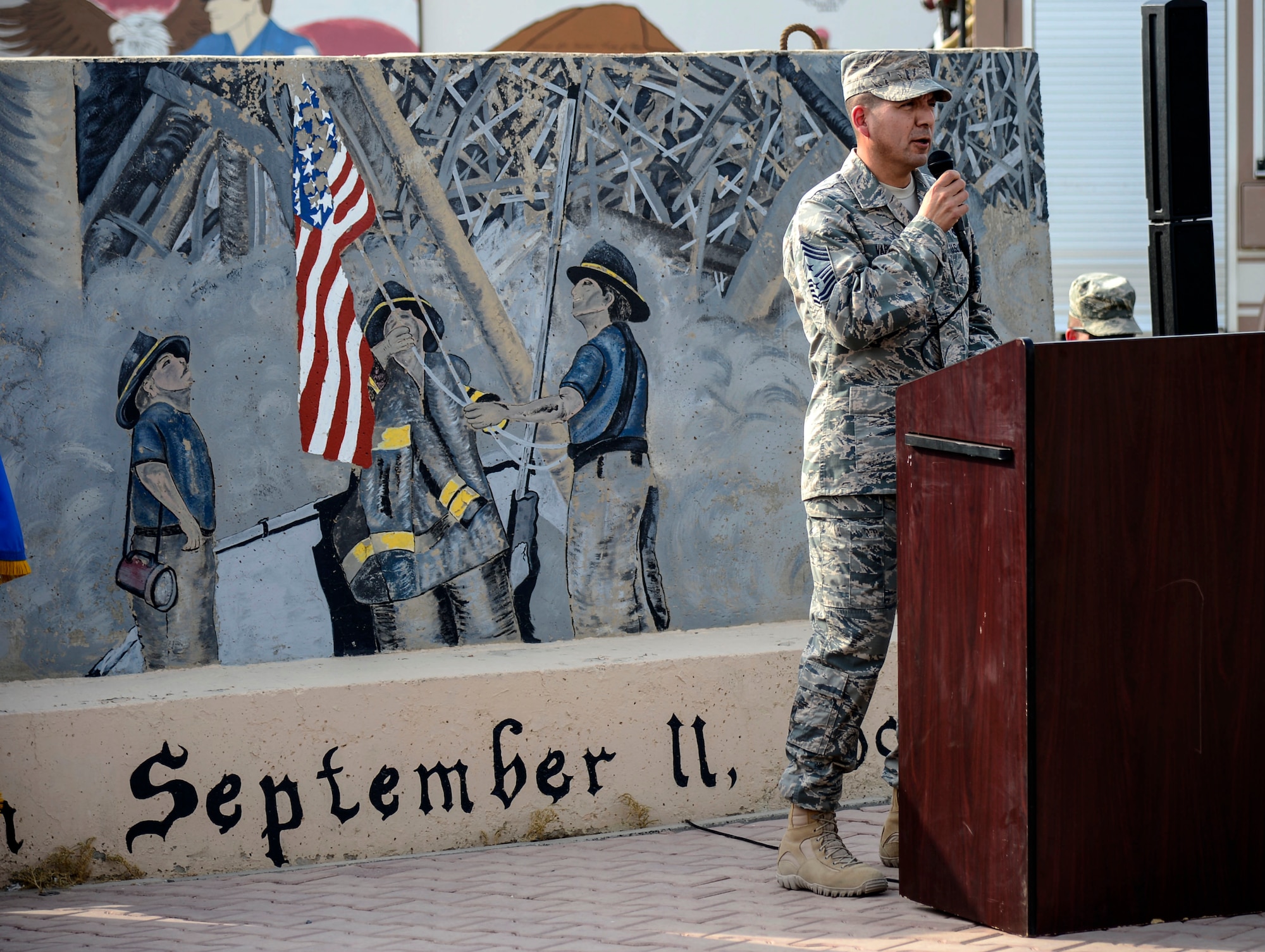 U.S. Air Force Chief Master Sgt. Richard Vargas, 386th Air Expeditionary Wing command chief, gives closing remarks during a 9/11 tribute ceremony at an undisclosed location in Southwest Asia, Sept. 11, 2015. On September 11, 2001, terrorists hijacked three passenger planes and carried out coordinated suicide attacks against the World Trade Center in New York City and the Pentagon in Washington, D.C., killing everyone on board the planes and nearly 3,000 people on the ground. A fourth plane crashed into a Pennsylvania field, killing all on board, after passengers and crew attempted to wrest control from the hijackers. (U.S. Air Force photo by Senior Airman Racheal E. Watson/Released)