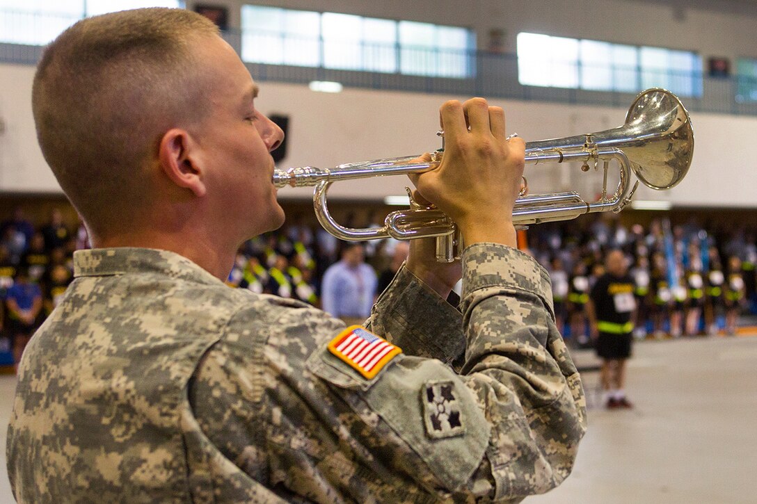 U.S. Army Staff Sgt. Christopher Beery, a trumpeter assigned to the U.S. Army Japan Band, plays taps during a 9/11 memorial ceremony on Camp Zama, Japan, Sept. 11, 2015. U.S. Army photo by Randall Baucom