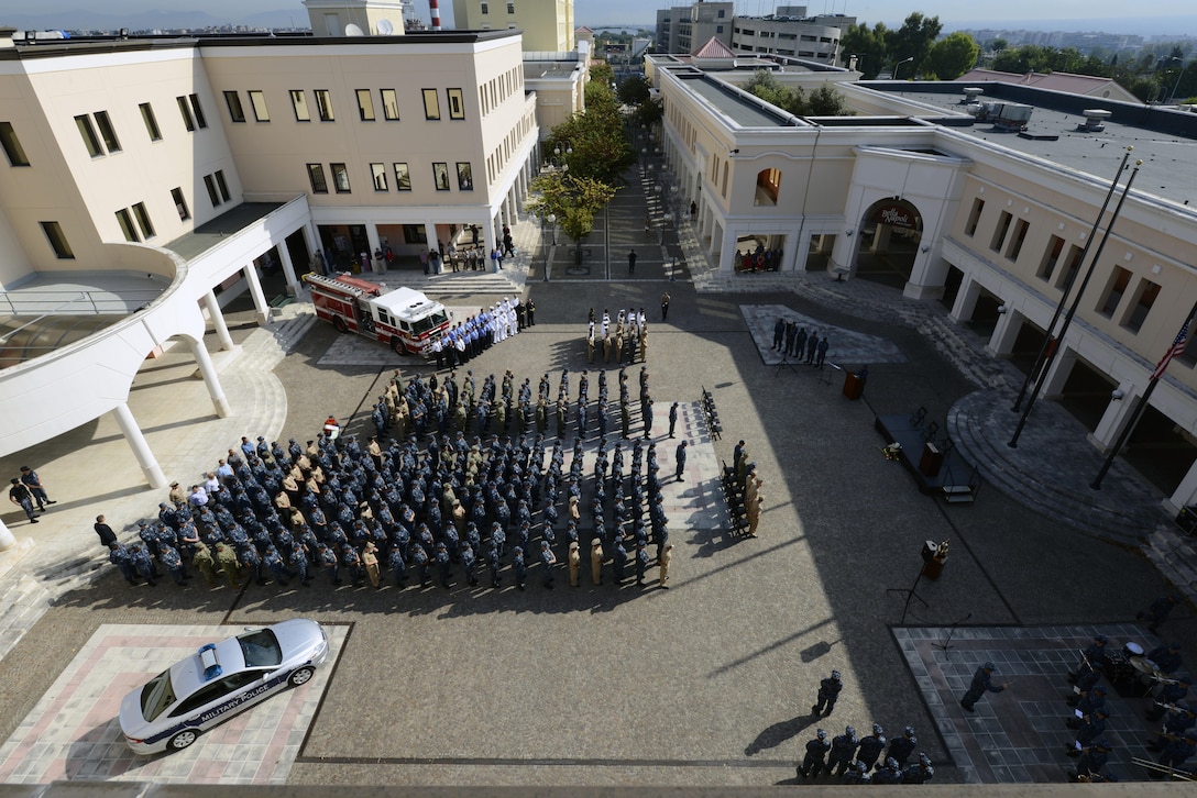 U.S. sailors and government employees stand in formation during a 9/11 remembrance ceremony in the Capodichino Piazza of U.S. Naval Support Activity Naples, Italy, Sept. 11, 2015. U.S. Navy photo by Chief Petty Officer Brian P. Biller