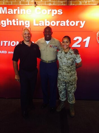 The Sergeant Major of the Marine Corps takes time to pose with SSgt Mayra Infante and Kyle Olson at the Marine Corps Warfighting Laboratory's booth during Marine Week Phoenix. 