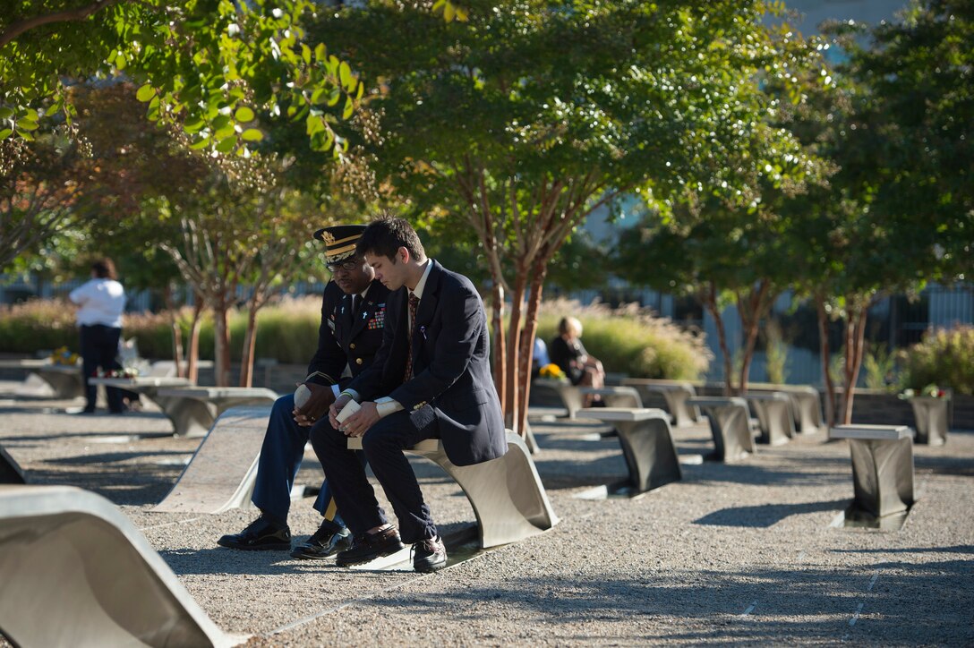 Family and friends of those killed on 9/11 at the Pentagon share a moment as Defense Secretary Ash Carter and Air Force Gen. Paul J. Selva, vice chairman of the Joint Chiefs of Staff, host a remembrance ceremony at the Pentagon Memorial, Sept. 11, 2015. DoD photo by U.S. Air Force Senior Master Sgt. Adrian Cadiz