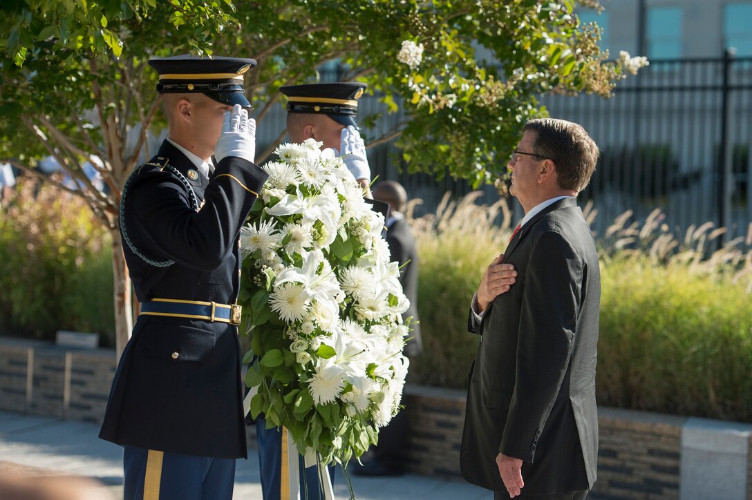 Defense Secretary Ash Carter renders honors after presenting a wreath at a remembrance ceremony at the Pentagon Memorial, Sept. 11, 2015, to honor the memory of those killed in the 9/11 terrorist attack. DoD photo by U.S. Air Force Senior Master Sgt. Adrian Cadiz