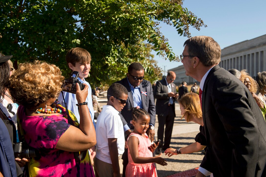 Defense Secretary Ash Carter greets guests following a remembrance ceremony at the Pentagon Memorial, Sept. 11, 2015, to honor the memory of those killed in the 9/11 terrorist attack 14 years ago. DoD photo by U.S. Air Force Senior Master Sgt. Adrian Cadiz