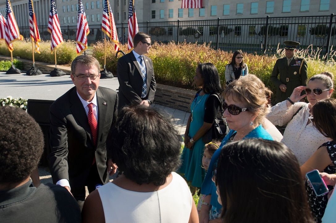 Defense Secretary Ash Carter greets guests following a remembrance ceremony at the Pentagon Memorial, Sept. 11, 2015, to honor the memory of those killed in the 9/11 terrorist attack. DoD photo by U.S. Air Force Senior Master Sgt. Adrian Cadiz