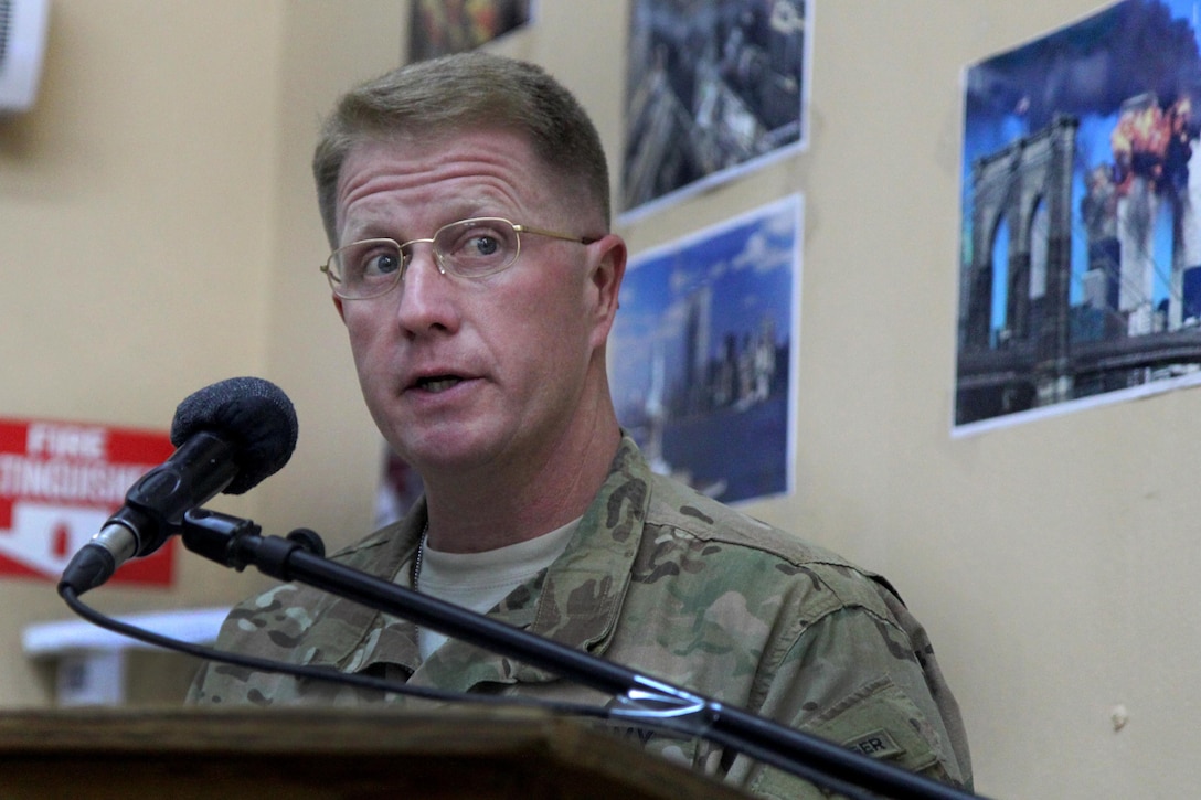 U.S. Army Brig. Gen. Christopher Bentley, commander of Train, Advise, Assist Command East, delivers a speech to honor Patriot Day and observe the 14th anniversary of the 9/11 attacks during a ceremony on Tactical Base Gamberi, Afghanistan, Sept. 11, 2015. U.S. Army photo by Capt. Charles Emmons