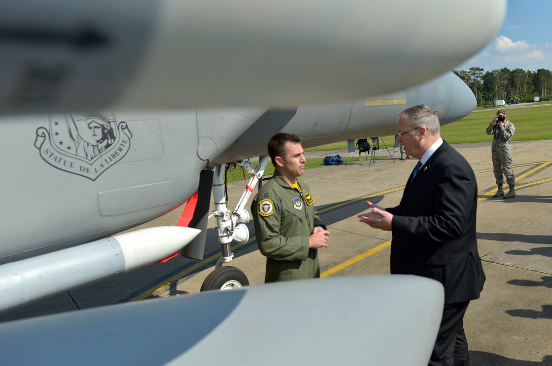 U.S. Air Force Capt. Tyler "Smoke" Marsh talks about an F-15C aircraft on display at Royal Air Force Lakenheath as U.S. Deputy Defense Secretary Bob Work visits U.S. Air Force operations on the base in England, Sept. 11, 2015. Marsh is a fighter pilot. DoD photo by Glenn Fawcett