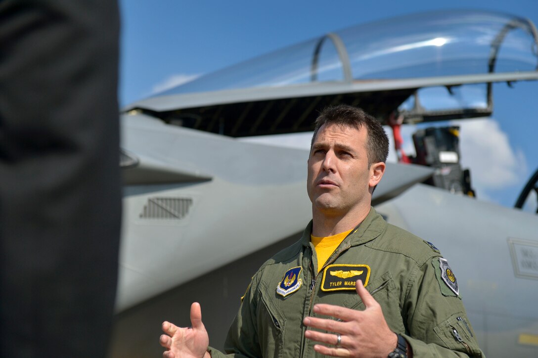 U.S. Air Force Capt. Tyler "Smoke" Marsh talks about an F-15C aircraft on display at Royal Air Force Lakenheath as U.S. Deputy Defense Secretary Bob Work visits U.S. Air Force operations on the base in England, Sept. 11, 2015. Marsh is a fighter pilot. DoD photo by Glenn Fawcett