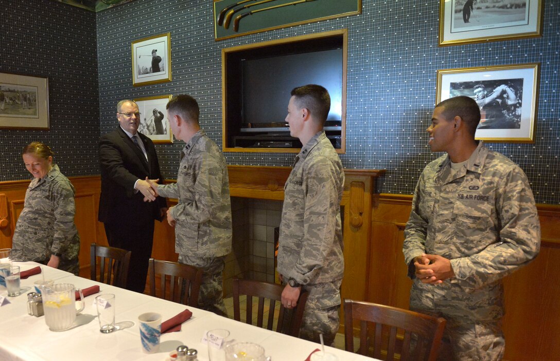 U.S. Deputy Defense Secretary Bob Work introduces himself to a group of U.S. Air Force junior officers as he prepares to join them for lunch on Royal Air Force Lakenheath, England, Sept. 11, 2015.
