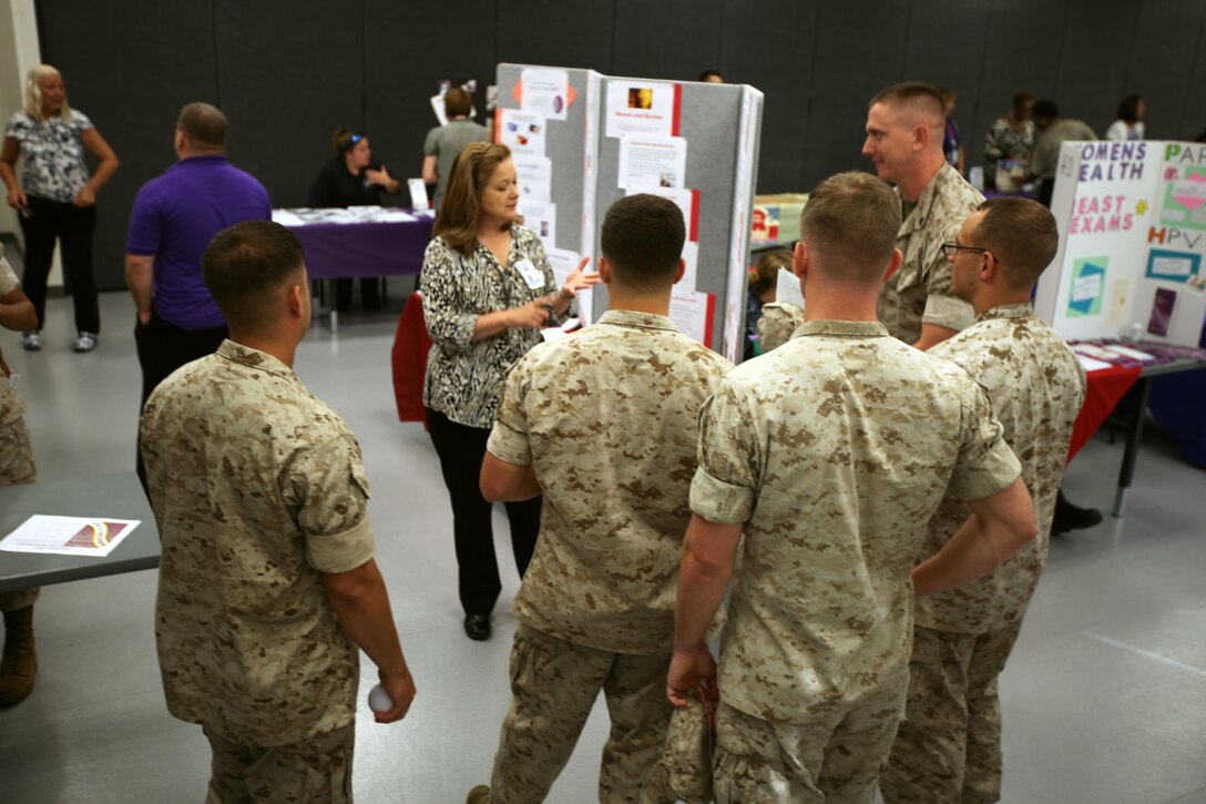 Paula A. Pendrick, center, educates a group of Marines about tobacco cessation during a Women’s Equality Day event at Marine Corps Air Station Cherry Point, N.C., Sept. 2, 2015. Women’s Equality Day is a day to celebrate women’s right to vote which began with the signing of the 19th Amendment, Aug. 26, 1920. Pendrick is the health promotions coordinator and tobacco cessation facilitator at the Cherry Point Naval Health Clinic. (U.S. Marine Corps photo by Pfc. Nicholas P. Baird/ released)
