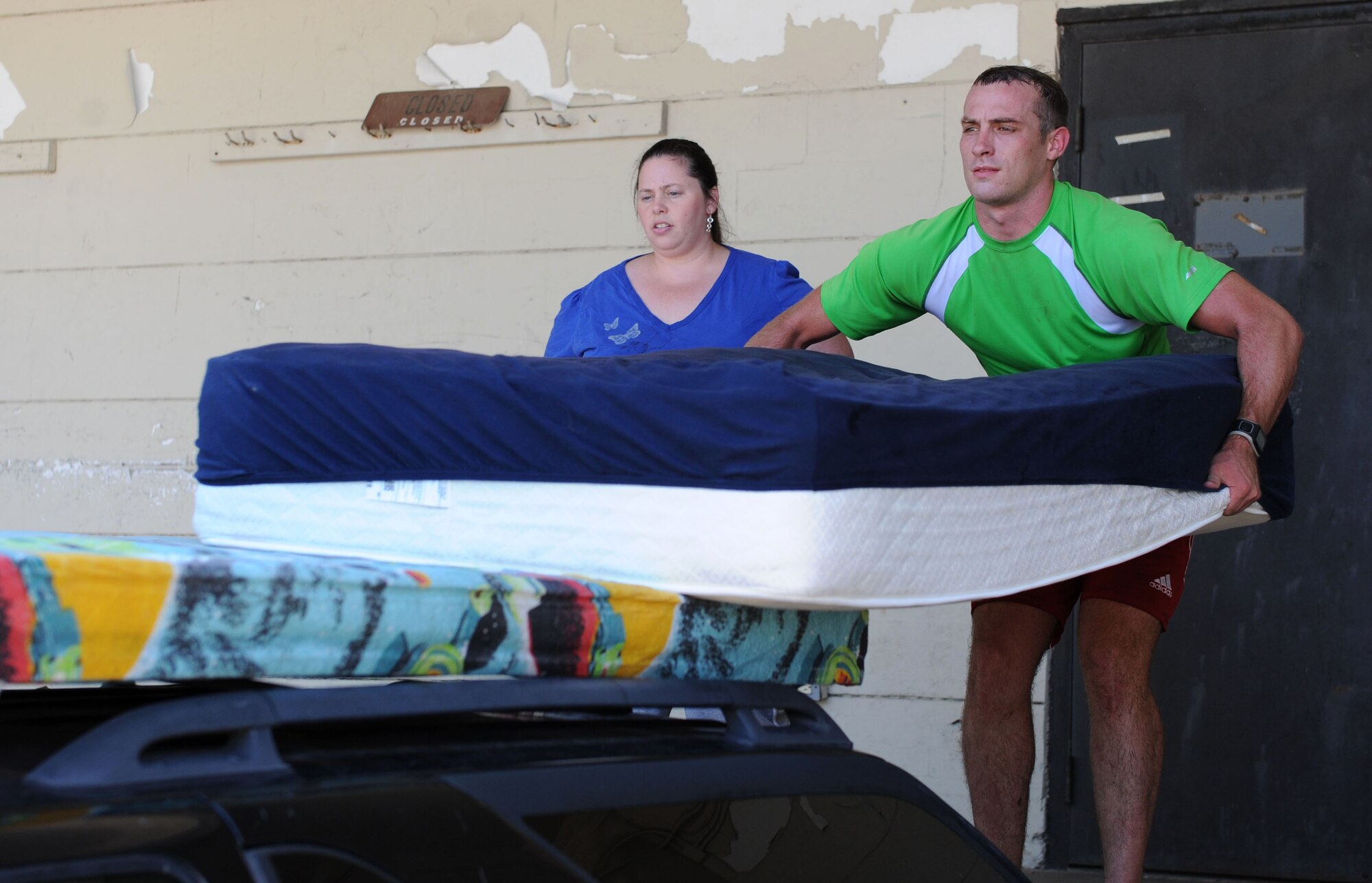 Teressa Vieira, Airman’s Attic manager, provides assistance to Senior Airman Jared Dickerson, 81st Diagnostic and Therapeutics Squadron radiology technician, as he loads mattresses at the Airman’s Attic Sept. 9, 2015, Keesler Air Force Base, Miss. The Airman’s Attic is available to service members ranked E-5 and below from all brances and their dependents. It contains donated household items such as furniture, electronics, kitchen items and clothes at no charge. Hours are 9 a.m. to 1 p.m. Mondays, Wednesdays and down Fridays. Items can be donated at any time by using the bin outside of the building. (U.S. Air Force photo by Kemberly Groue)