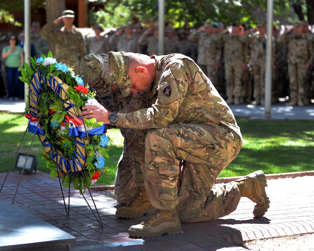 U.S. Army Gen. John. F. Campbell, left, commander of Resolute Support Mission U.S. Forces Afghanistan and U.S. Army Command Sgt. Maj. Delbert Byers share a moment of silence observing the anniversary of the 9/11 attacks during a wreath-laying ceremony in Kabul, Afghanistan, Sept. 11, 2015. U.S. Air Force photo by Tech. Sgt. Robert Sizelove