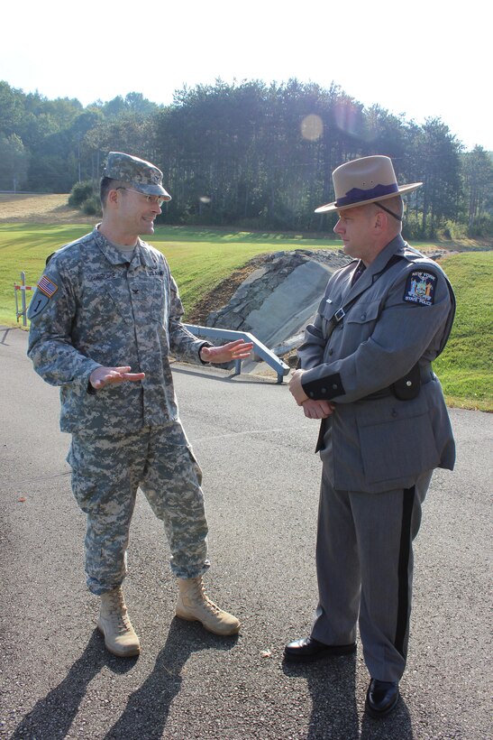 U.S. Army Corps of Engineers Baltimore District commander Col. Ed Chamberlayne (left) honors New York State Trooper Donald Atkinson with a coin and certificate of appreciation for heroically saving a young girl's life in July at Whitney Point Dam.