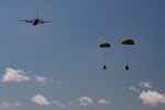 A C-130 assigned to the North Carolina Air National Guard, drops bundles of rice over Baucau Airport, Sept. 8, 2015, near Baucau, Timor-Leste. The rice was donated to a local orphanage as part of Operation Pacific Angel 15-2. Efforts undertaken during Pacific Angel help multilateral militaries in the Pacific improve and build relationships across a wide spectrum of civic operations, which bolsters each nation’s capacity to respond and support future humanitarian assistance and disaster relief operations. 