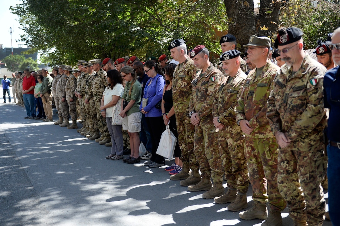 Coalition, U.S. service members and civilians render honors on the anniversary of the 9/11 attacks during a wreath-laying ceremony in Kabul, Afghanistan, Sept. 11, 2015. U.S. Navy photo by Lt. Kristine Volk