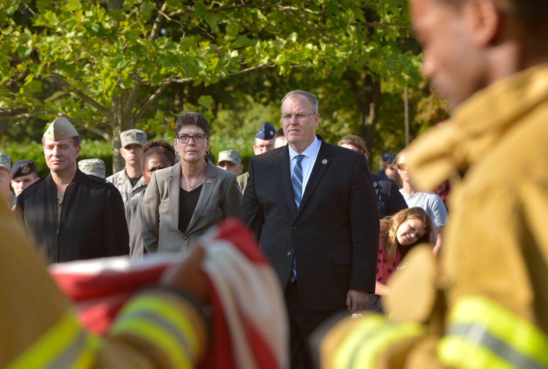 U.S. Deputy Defense Secretary Bob Work and his wife, Cassandra, pay their respects to those who lost their lives in the 9/11 attacks during a remembrance ceremony on Royal Air Force Lakenheath, England, Sept. 11, 2015. DoD photo by Glenn Fawcett