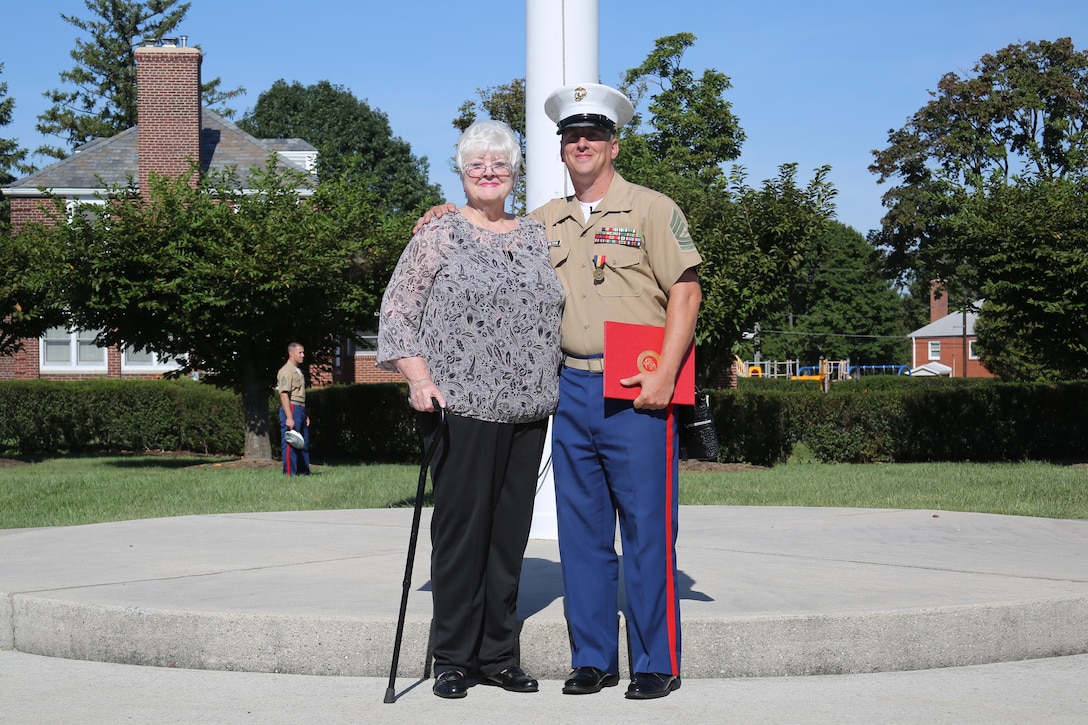 U.S. Marine Corps Master Sgt. Jay Wilfrom the adjutant chief for the 4th Marine Corps District and Pittsburgh, Pennsylvania, native poses with Loretta Marburger at the Defense Distribution Center Susquehanna in New Cumberland, Pennsylvania Sept. 11, 2015 after receiving his second Navy Marine Corps Medal. He received his first in 1995 for saving a teenage military dependent from drowning in Iwakuni, Japan. He received his second for saving Marbuger from her burning house in 2014. (U.S. Marine Corps photo by Cpl. Tyler Birky/Released)