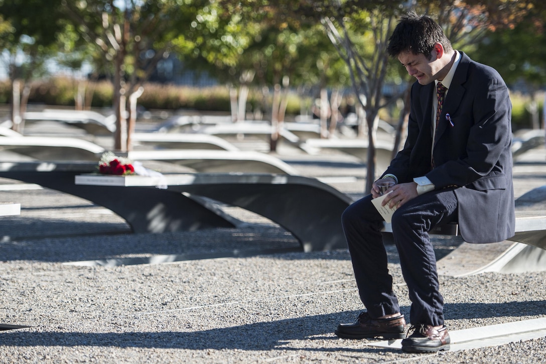 A man weeps at the memorial unit of a loved one at the Pentagon Memorial before a remembrance ceremony honoring those lost in the 9/11 attack, Sept. 11, 2015. DoD photo by Petty Officer 2nd Class Dominique A. Pineiro