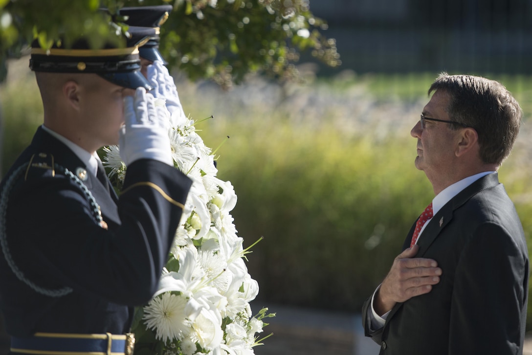Defense Secretary Ash Carter places a wreath at the Pentagon Memorial during a remembrance ceremony honoring those lost in the 9/11 attack, Sept. 11, 2015. DoD photo by Petty Officer 2nd Class Dominique A. Pineiro