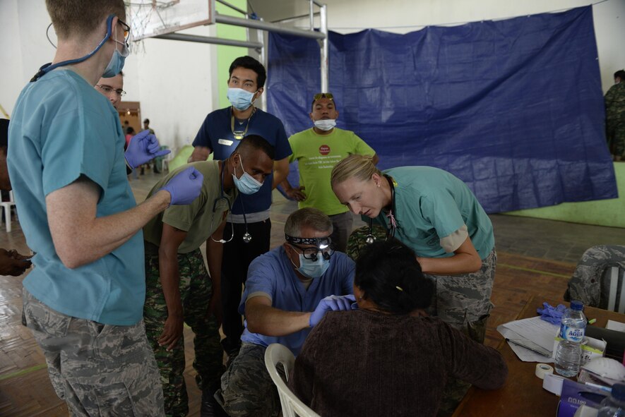 Pacific Angel 15-2 general practice physicians and dentists take a look at a patient's oral sore during a health services outreach Sept. 11, 2015, in Baucau, Timor-Leste. Pacific Angel is a multilateral humanitarian assistance civil military operation, which improves military-to-military partnerships in the Pacific while also providing medical health outreach, civic engineering projects and subject matter exchanges among partner forces. (U.S. Air Force photo by Staff Sgt. Alexander W. Riedel/Released)