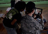 U.S. Air Force Maj. Shannon Brodersen, 141st Medical Group family practice physician, takes a selfie with local kids during a Pacific Angel 15-2 healh services outreach Sept. 9, 2015, in Baucau, Timor-Leste. Pacific Angel is a multilateral humanitarian assistance civil military operation, which improves military-to-military partnerships in the Pacific while also providing medical health outreach, civic engineering projects and subject matter exchanges among partner forces. (U.S. Air Force photo by Staff Sgt. Alexander W. Riedel/Released)