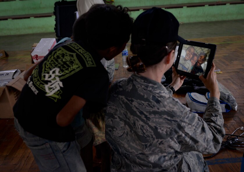 U.S. Air Force Maj. Shannon Brodersen, 141st Medical Group family practice physician, takes a selfie with local kids during a Pacific Angel 15-2 healh services outreach Sept. 9, 2015, in Baucau, Timor-Leste. Pacific Angel is a multilateral humanitarian assistance civil military operation, which improves military-to-military partnerships in the Pacific while also providing medical health outreach, civic engineering projects and subject matter exchanges among partner forces. (U.S. Air Force photo by Staff Sgt. Alexander W. Riedel/Released)