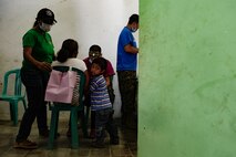 U.S. Navy Lt. David L. Sandberg, 1st Medical Logistics Group, examines a young mother's teeth during a Pacific Angel health services outreach Sept. 9, 2015, in Baucau, Timor-Leste. Pacific Angel is a multilateral humanitarian assistance civil military operation, which improves military-to-military partnerships in the Pacific while also providing medical health outreach, civic engineering projects and subject matter exchanges among partner forces. (U.S. Air Force photo by Staff Sgt. Alexander W. Riedel/Released)