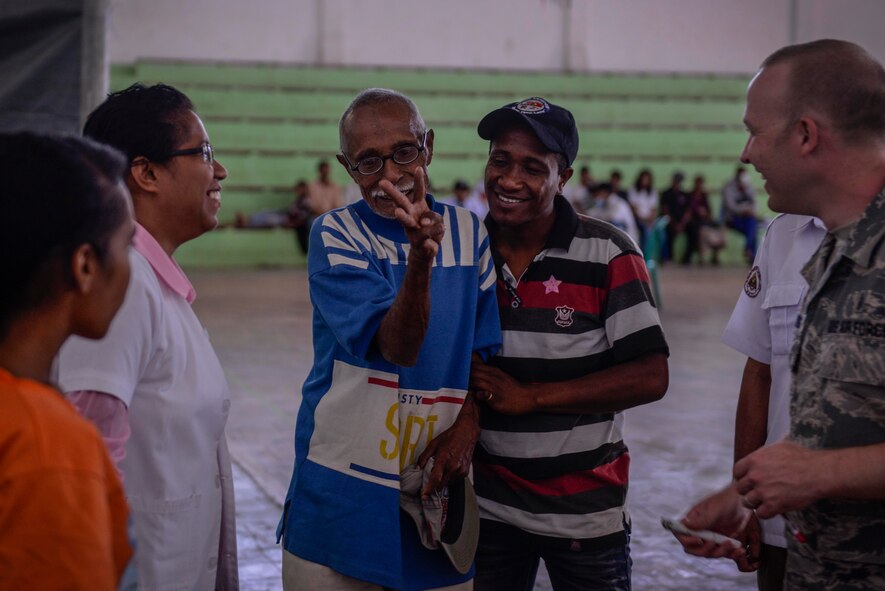 U.S. Air Force Tech. Sgt. Zachary Clemmons, 354th Medical Group optometry technician, observes as an optometry patient happily confirms that his new glasses greatly improved his vision during an Operation Pacific Angel 15-2 health services outreach Sept. 7, 2015, in Baucau, Timor-Leste. Pacific Angel is a multilateral humanitarian assistance civil military operation, which improves military-to-military partnerships in the Pacific while also providing medical health outreach, civic engineering projects and subject matter exchanges among partner forces. (U.S. Air Force photo by Staff Sgt. Alexander W. Riedel/Released)