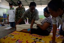 U.S. Air Force Tech. Sgt.  Crissy Sharpe, 36th Medical Group physical therapy technician,  explains therapeutic exercises to a patient during a Pacific Angel 15-2 health services outreach Sept. 9, 2015, in Baucau, Timor-Leste. Pacific Angel is a multilal humanitarian assistance civil military operation, which improves military-to-military partnerships in the Pacific while also providing medical health outreach, civic engineering projects and subject matter exchanges among partner forces.
(U.S. Air Force photo by Staff Sgt. Alexander W. Riedel/Released)