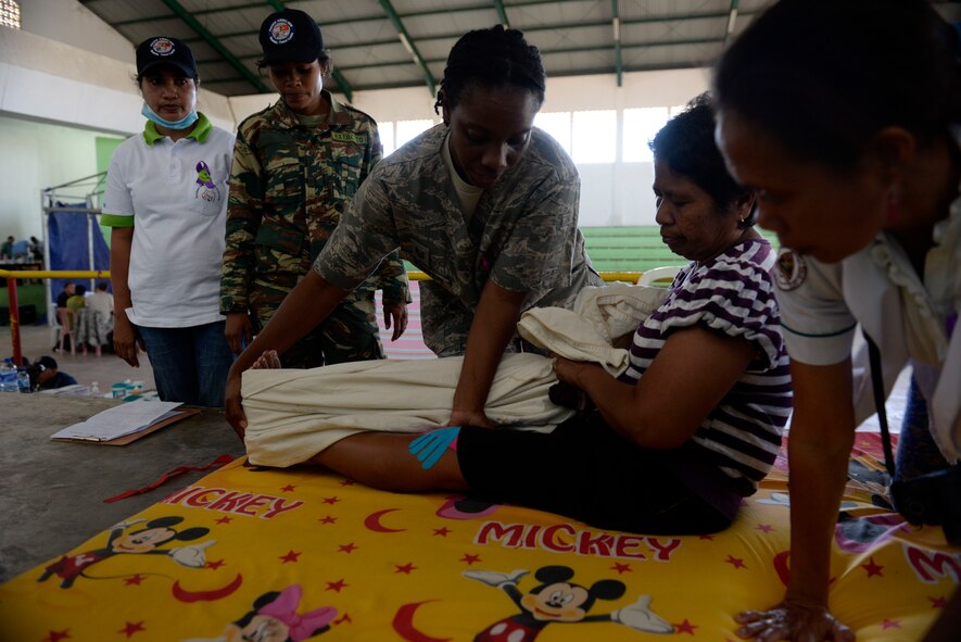 U.S. Air Force Tech. Sgt.  Crissy Sharpe, 36th Medical Group physical therapy technician,  explains therapeutic exercises to a patient during a Pacific Angel 15-2 health services outreach Sept. 9, 2015, in Baucau, Timor-Leste. Pacific Angel is a multilal humanitarian assistance civil military operation, which improves military-to-military partnerships in the Pacific while also providing medical health outreach, civic engineering projects and subject matter exchanges among partner forces.
(U.S. Air Force photo by Staff Sgt. Alexander W. Riedel/Released)