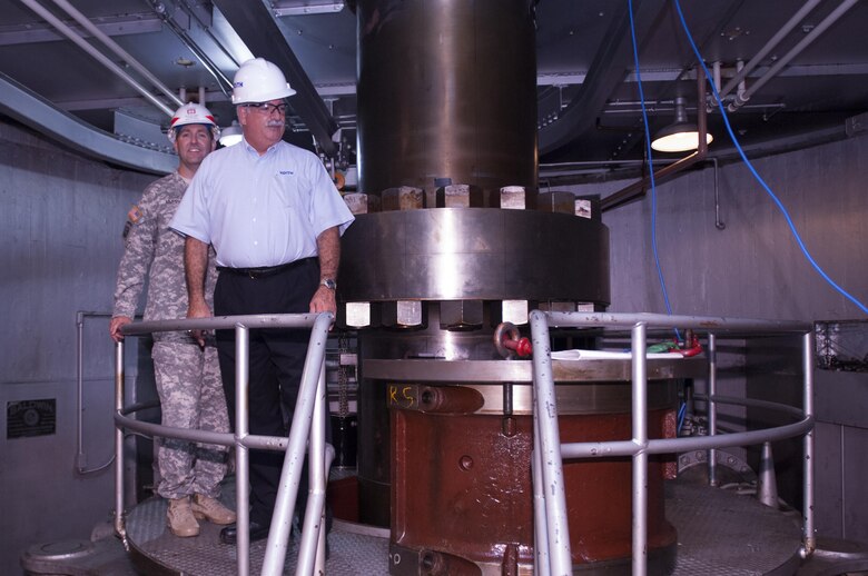 Lt. Col. Stephen F. Murphy (Left), U.S. Army Corps of Engineers Nashville District commander, and Bob Gallo, Voith Hydro chief executive officer, look at the turbine shaft of hydropower unit two at the Center Hill Dam Power House in Lancaster, Tenn., Sept. 9, 2015.