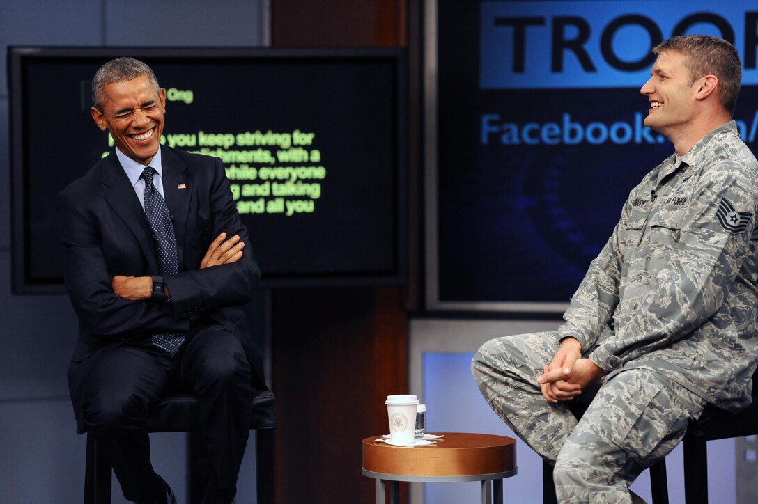 President Barack Obama shared a light moment with service members during his worldwide troop talk as Air Force Tech. Sgt. Nathan Parry, the event's moderator, looks on from the studios on Fort Meade, Md., Sept. 11, 2015. DoD photo by Marvin Lynchard