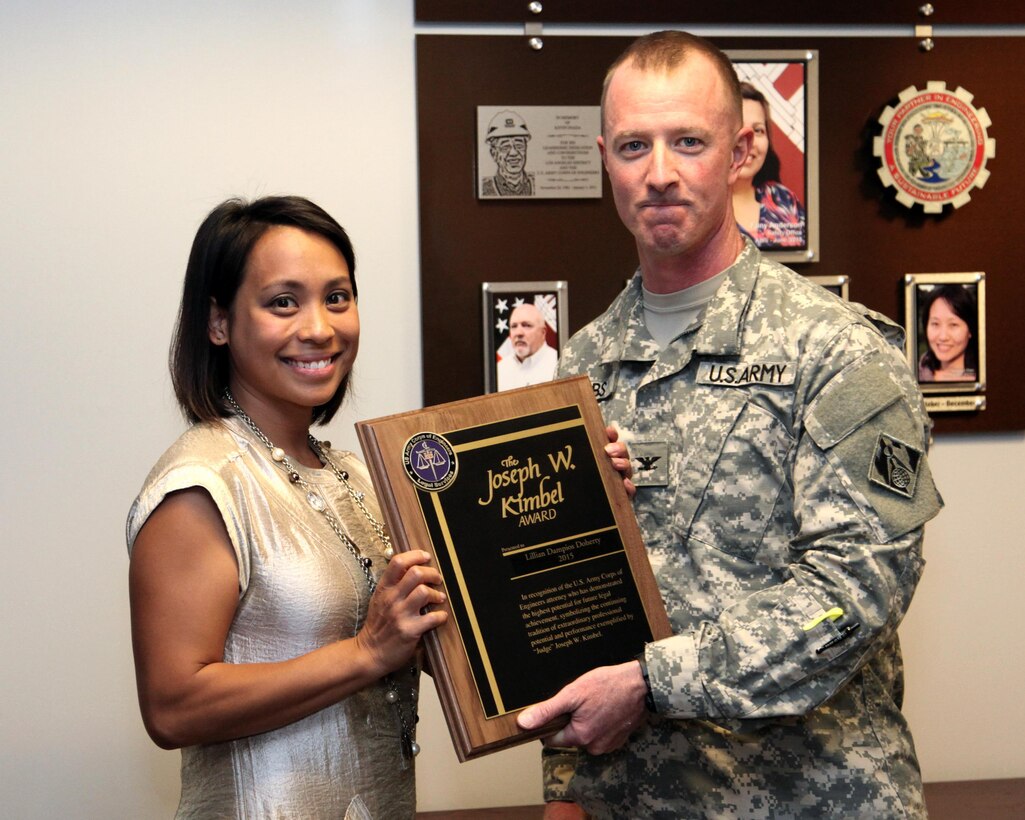 Col. Kirk Gibbs, Los Angeles District commander, presents the Joseph W. Kimbel Award to Lillian Dampios Sept. 8 in Los Angeles. The award recognizes the lawyer who demonstrates the highest potential for future legal achievement within the Corps.