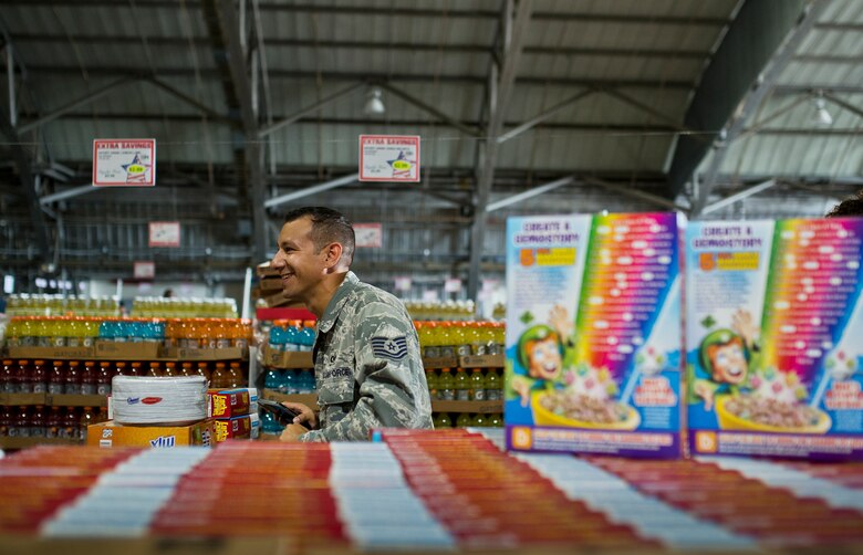 A technical sergeant moves his cart up the final aisle of deals at the commissary case lot sale at Duke Field, Fla., Sept. 11.  Patrons waited in line for at least 30 minutes to receive the special sales prices. The three-day sale was open to military, retirees, family members and had special hours for reservists. (U.S. Air Force photo/Tech. Sgt. Sam King)
