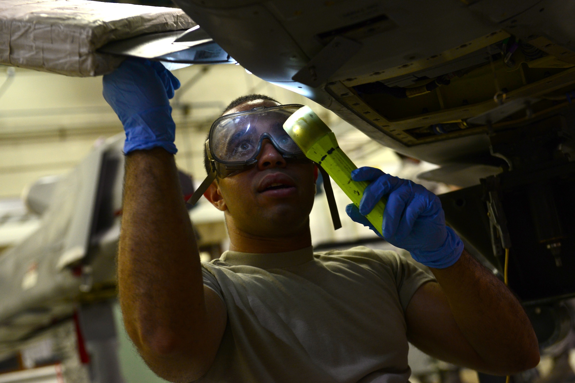Airman 1st Class Aramis Quinones-Tirado, 2nd Munitions Squadron cruise missile maintenance technician, tightens a screw on a conventional air-launched cruise missile at Barksdale Air Force Base, La., Aug. 29, 2015. Cruise missile maintainers must stay proficient at multiple tasks such as fueling, engine work and loading. (U.S. Air Force Photo/Airman 1st Class Luke Hill)