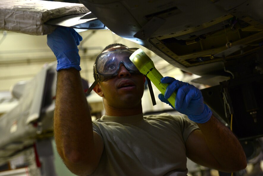 Airman 1st Class Aramis Quinones-Tirado, 2nd Munitions Squadron cruise missile maintenance technician, tightens a screw on a conventional air-launched cruise missile at Barksdale Air Force Base, La., Aug. 29, 2015. Cruise missile maintainers must stay proficient at multiple tasks such as fueling, engine work and loading. (U.S. Air Force Photo/Airman 1st Class Luke Hill)