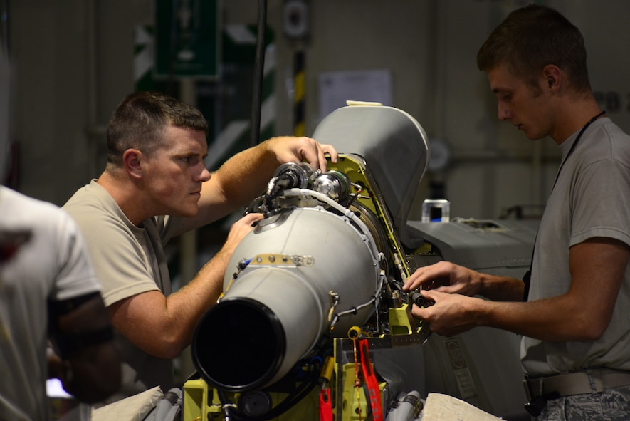 Senior Airman Nathaniel Williams, left, 2nd Munitions Squadron cruise missile team chief, and Senior Airman Scott Croft, 2nd MUNS cruise missile maintenance technician, work on a conventional air-launched cruise missile engine at Barksdale Air Force Base, La., Aug. 29, 2015. Maintenance on cruise missiles is tedious work and maintainers have to follow specific instructions precisely to ensure the missile is safe and effective. (U.S. Air Force Photo/Airman 1st Class Luke Hill)