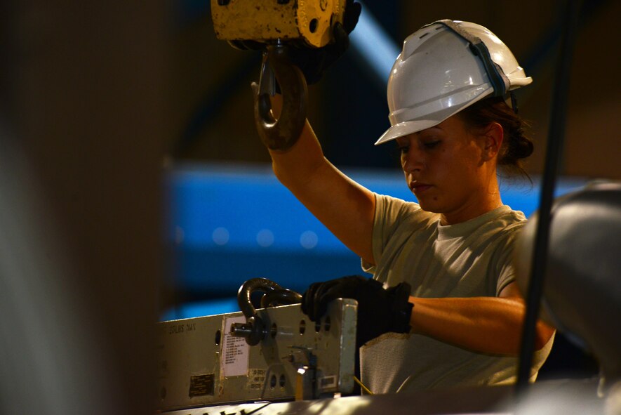 Senior Airman Jeanne Rhoads, 2nd Munitions Squadron cruise missile team chief, detaches a cruise missile from a lift at Barksdale Air Force Base, La., Aug. 29, 2015. The conventional air-launched cruise missile travels at 550 miles per hour and delivers a 3,000 pound fragmentation warhead. (U.S. Air Force Photo/Airman 1st Class Luke Hill)