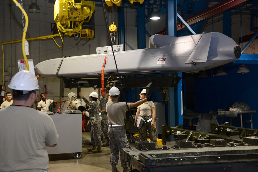 Airmen from the 2nd Munitions Squadron cruise missile flight lower a conventional air-launched cruise missile onto a dolly so it can be loaded at Barksdale Air Force Base, La., Aug. 29, 2015. The cruise missile contains a 3,000 pound warhead and must be handled with utmost caution. (U.S. Air Force Photo/Airman 1st Class Luke Hill)