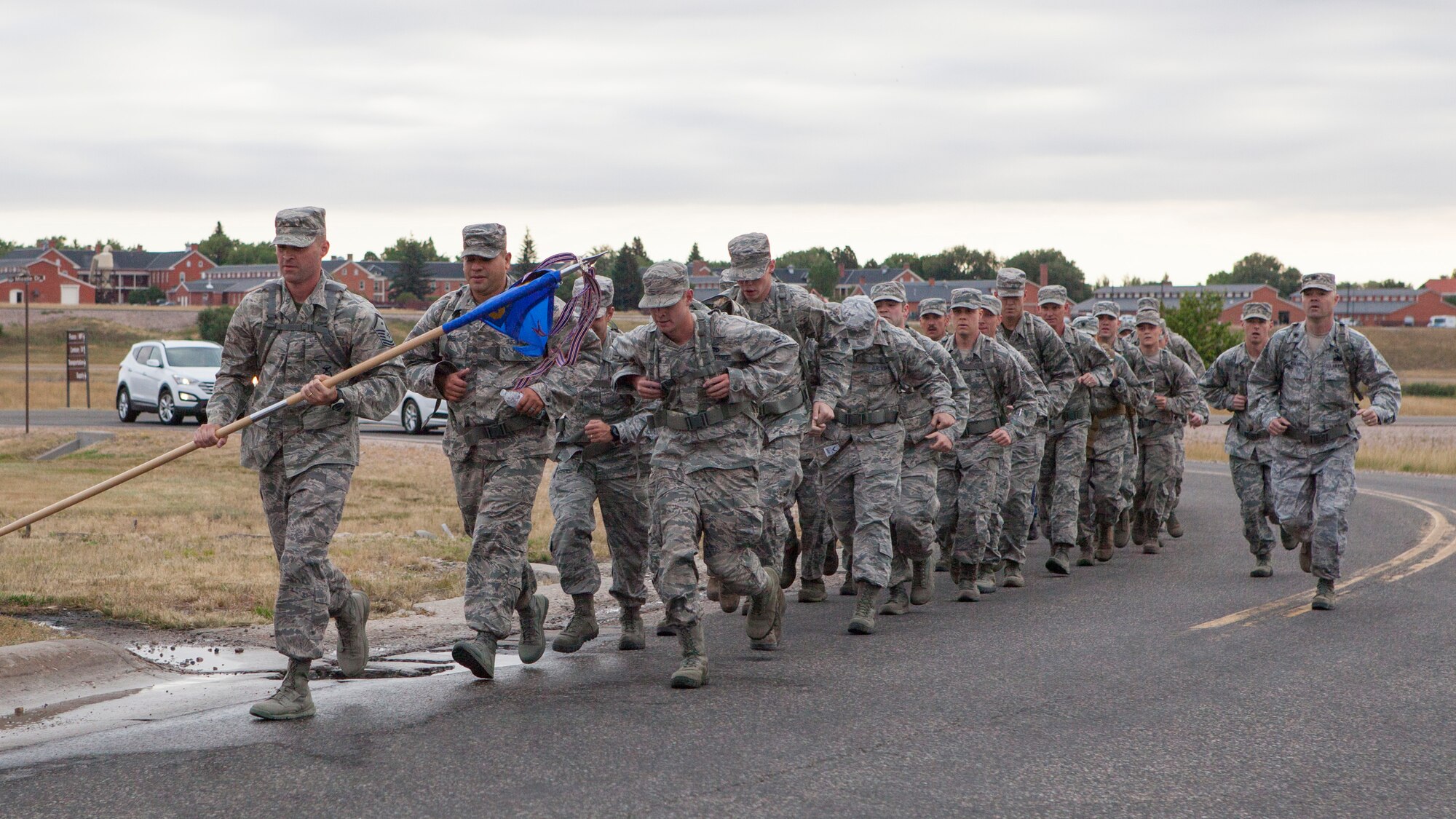 Airmen from 90th Logistics Readiness Squadron run the last stretch of road back to their original ruck march start point on F.E. Warren Air Force Base, Wyo., Sept. 11 2015. The march commemorated the Sept. 11 attacks against the U.S. (U.S. Air Force photo by Lan Kim)