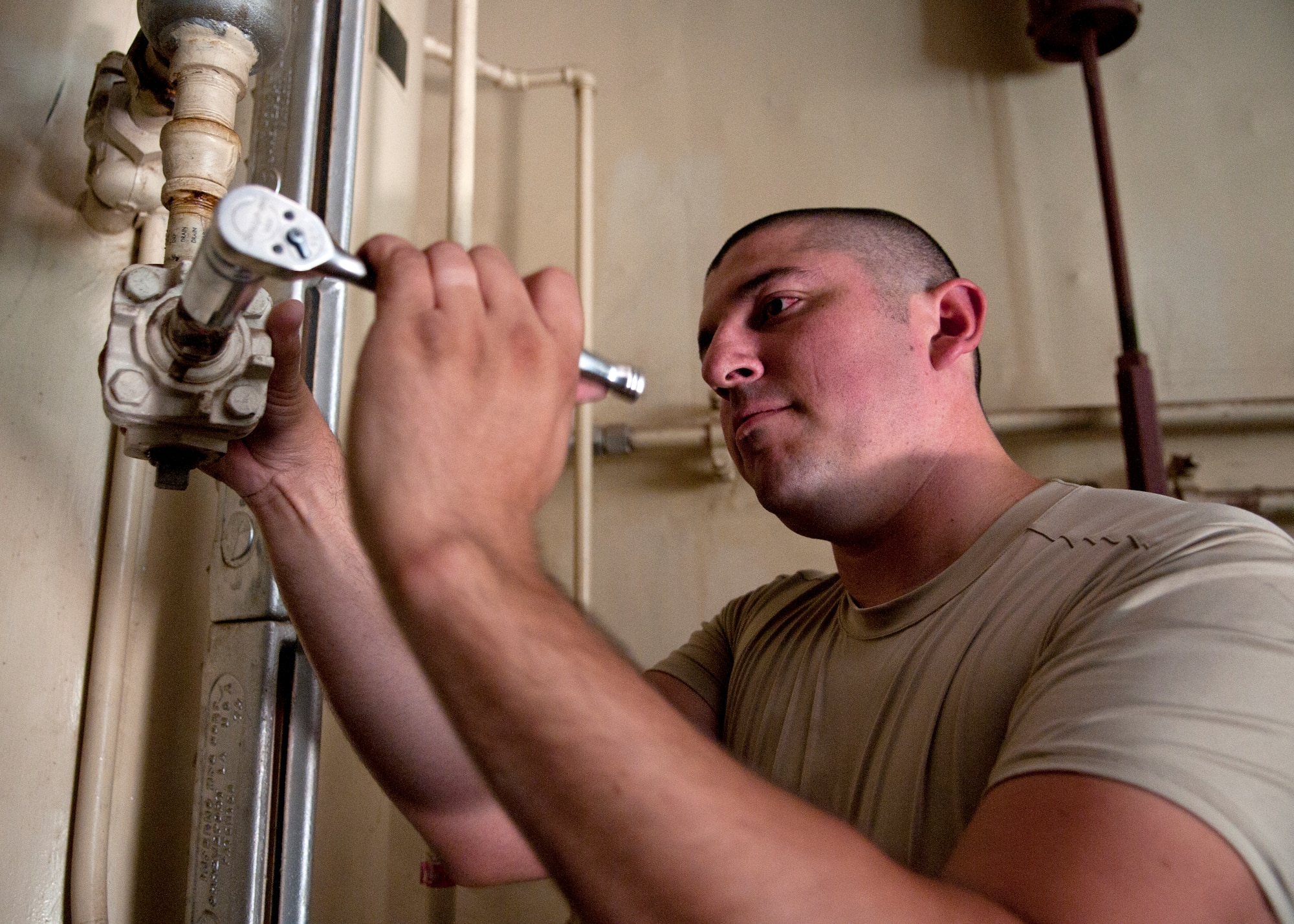 Airman 1st Class Christopher Myers, 90th Missile Maintenance Squadron Periodic Maintenance Team technician, tightens a portion of the fuel line valves in the launch support building for a Minuteman III launch facility, in the F.E. Warren Air Force base, Wyo., missile complex, Sept. 2, 2015. The PMT conducts various tasks to ensure the longevity of the equipment in the launch support building. (U.S. Air Force photo by Airman 1st Class Malcolm Mayfield)