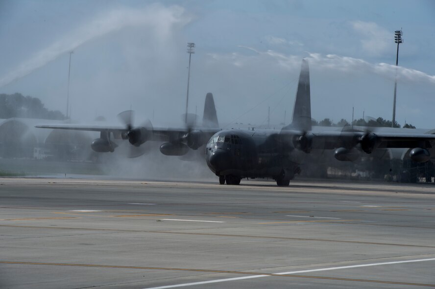 HC-130P Combat King number 64-14852 travels under an arc of water signifying its final flight Sept. 11, 2015, at Moody Air Force Base, Ga. The aircraft was manufactured on November 30, 1965 and has more than 17,500 flight hours. (U.S. Air Force photo by Staff Sgt. Eric Summers Jr./Released)