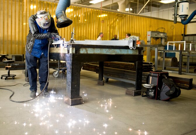 Rich Samanich, 57th Maintanence Group aircraft metals technology lead, cuts through metal at the Aircraft Metals Technology shop on Nellis Air Force Base, Nev., Sept. 3, 2015. Metals technology requires precision and attention to detail. (U.S. Air Force photo by Airman 1st Class Rachel Loftis)