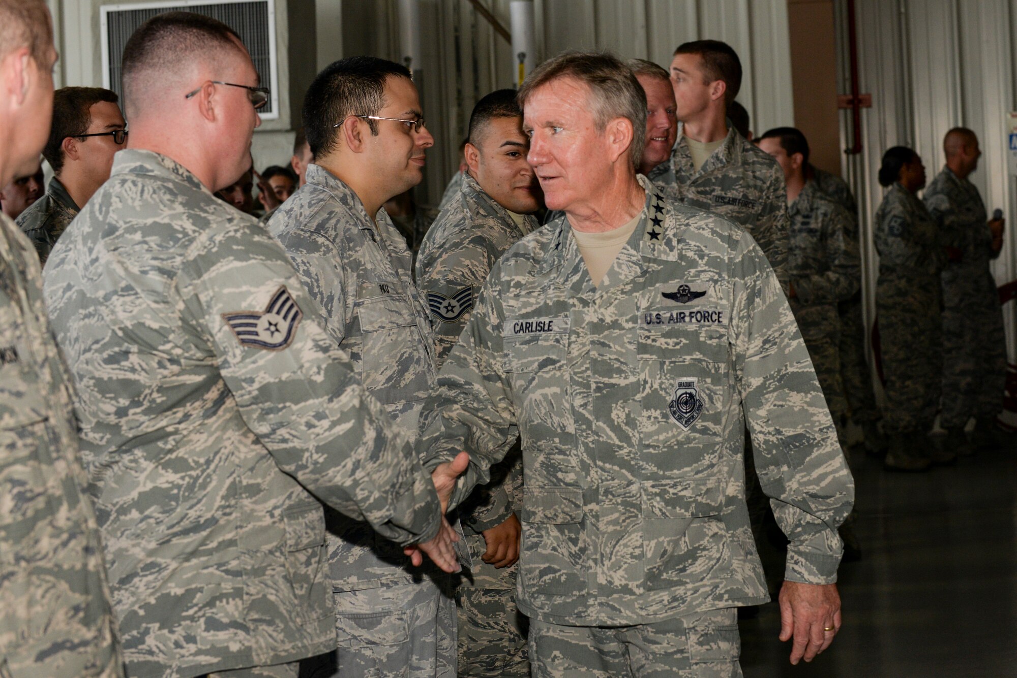 U.S. Air Force Gen. Hawk Carlisle, commander of Air Combat Command, shakes hands with Airmen of the 4th Fighter Wing after an all call, Sept. 9, 2015, at Seymour Johnson Air Force Base, North Carolina. During his speech, Carlisle discussed his command priorities and the future of ACC and Seymour Johnson AFB. (U.S. Air Force photo/Airman 1st Class Ashley Williamson)