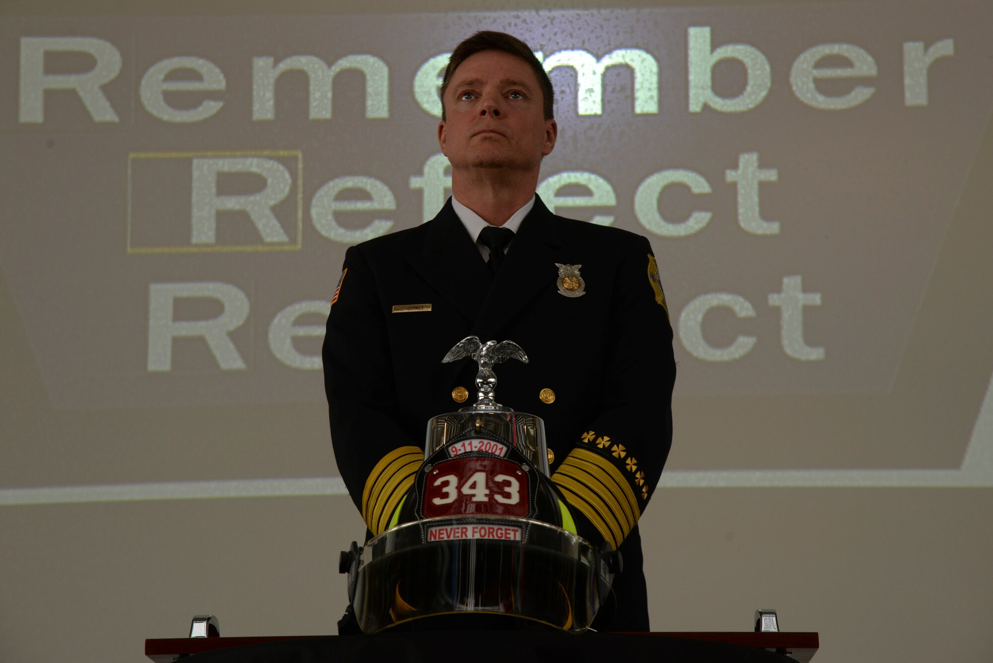 Sean Quinby, 4th Civil Engineer Squadron fire chief, prepares to begin a bell ringing ceremony as part of a 9/11 Remembrance ceremony, Sept. 11, 2015, at Seymour Johnson Air Force Base, North Carolina. Quinby rang the bell nine times, signifying the end of duty for the first responders lost during the attacks on 9/11. (U.S. Air Force photo/Staff Sgt. Chuck Broadway)
