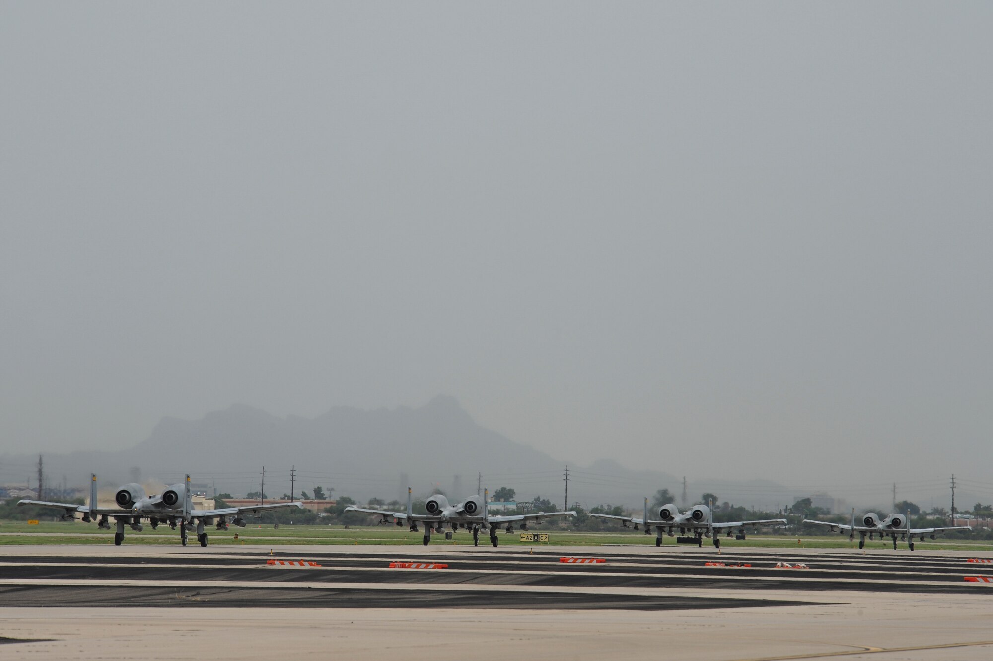 Four A-10C Thunderbolt IIs from the 357th Fighter Squadron taxi down the flight line at Davis-Monthan Air Force Base, Ariz., Sept. 10, 2015, before departing for Nellis Air Force Base, Nev., to participate in Green Flag 15-10.  Green Flag is an advanced, realistic and relevant air to surface training exercise that prepares joint and coalition warfighters to meet combatant commander requirements across air, space and cyberspace.  (U.S. Air Force photo by Senior Airman Chris Massey/Released)