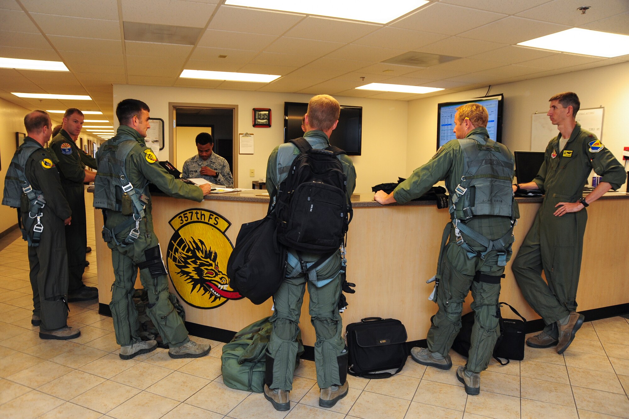 U.S. Air Force A-10C Thunderbolt II pilots from the 357th Fighter Squadron listen to preflight briefings at Davis-Monthan Air Force Base, Ariz., Sept. 10, 2015, prior to departing for Nellis Air Force Base, Nev., to participate in Green Flag 15-10.  Green Flag is an advanced, realistic and relevant air to surface training exercise that prepares joint and coalition warfighters to meet combatant commander requirements across air, space and cyberspace.  (U.S. Air Force photo by Senior Airman Chris Massey/Released)