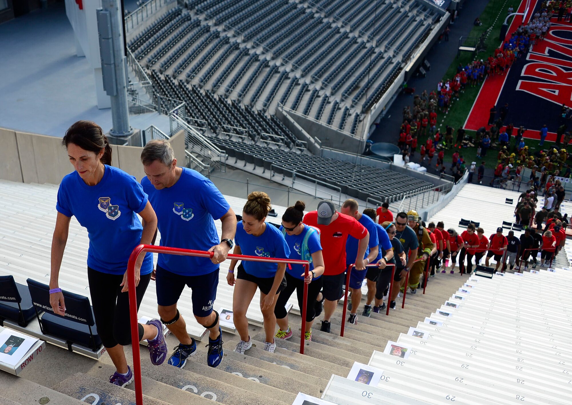 Military members and spouses of 12th Air Force (Air Forces Southern) joined the Tucson community during the 9/11 Tower Challenge at the University of Arizona football stadium in Tucson, Ariz., Sept. 11, 2015. The 9/11 Tower Challenge was held to honor those who lost their lives during the Sept. 11, 2001 attacks and to show their support first responders and military members who continue to protect the U.S. from foreign and domestic threats. During the 9/11 Tower Challenge, participants climbed 2,071 steps representing the number of steps that were in the Twin Towers. (U.S. Air Force Photo by Tech. Sgt. Heather R. Redman/Released)