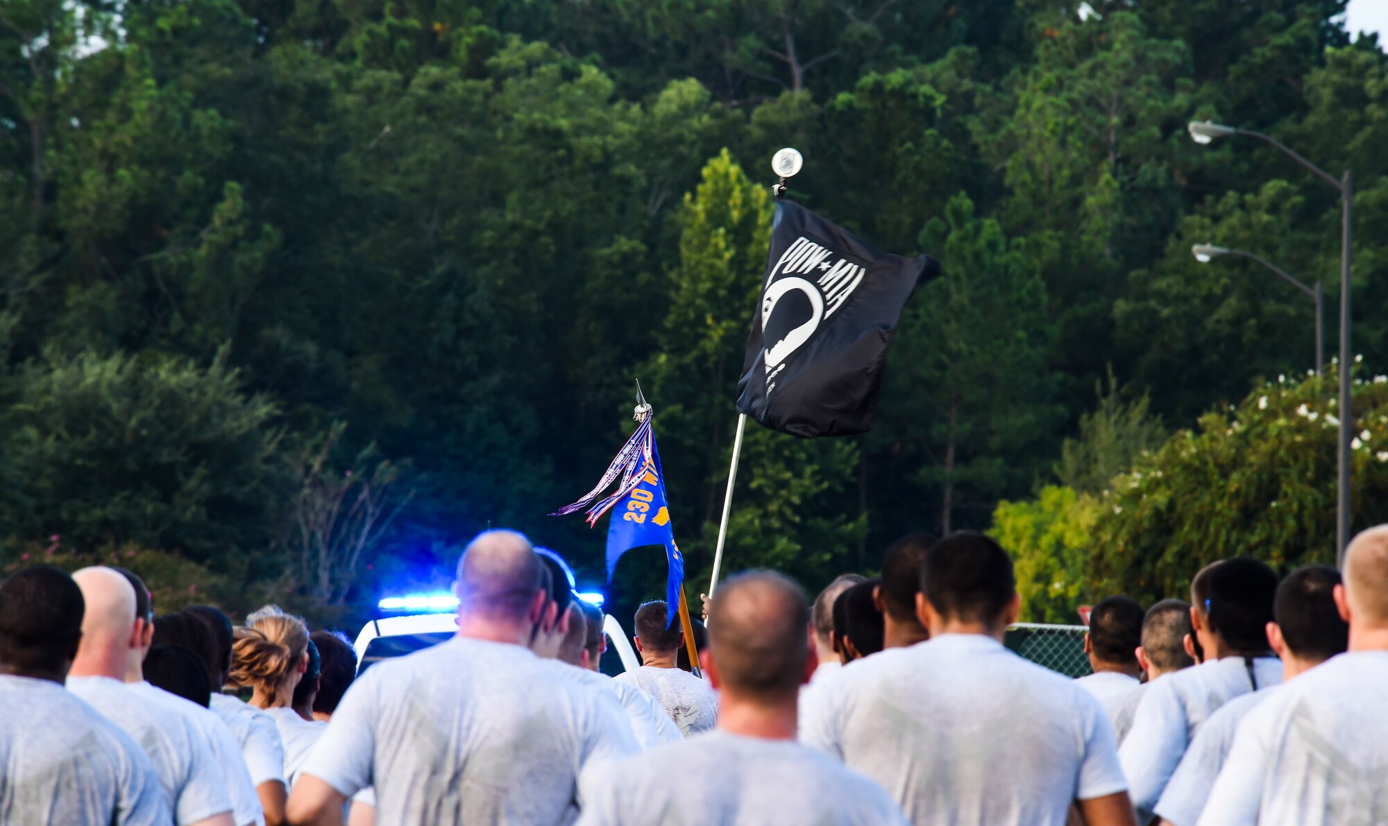 Airmen from the 23d Communications Squadron carry a prisoner -of-war and missing- in-action flag during the Tiger-thon Sept. 11, 2015, at Moody Air Force Base, Ga The 23-mile run was completed in one-mile increments by different organizations in honor of those POW/MIA. (U.S. Air Force photo by Senior Airman Ceaira Tinsley/Released)