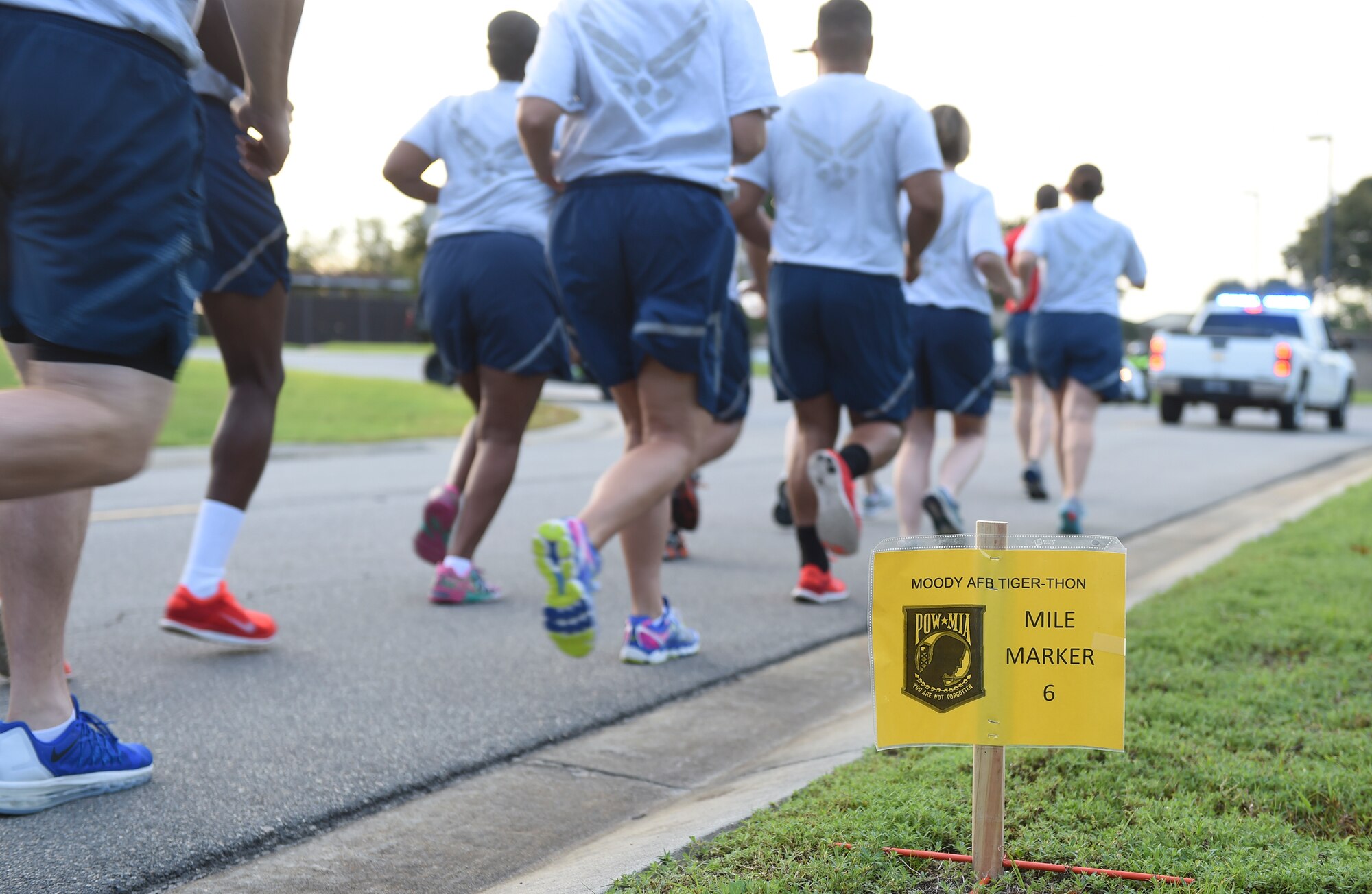 Airmen from the 23d Force Support Squadron participate in the Tiger-thon Sept. 11, 2015, at Moody Air Force Base, Ga. Individuals from different organizations ran one-mile increments and then passed the flag off to the next organization to honor prisoners of war and those missing in action the during the event. (U.S. Air Force photo by Senior Airman Ceaira Tinsley/Released)